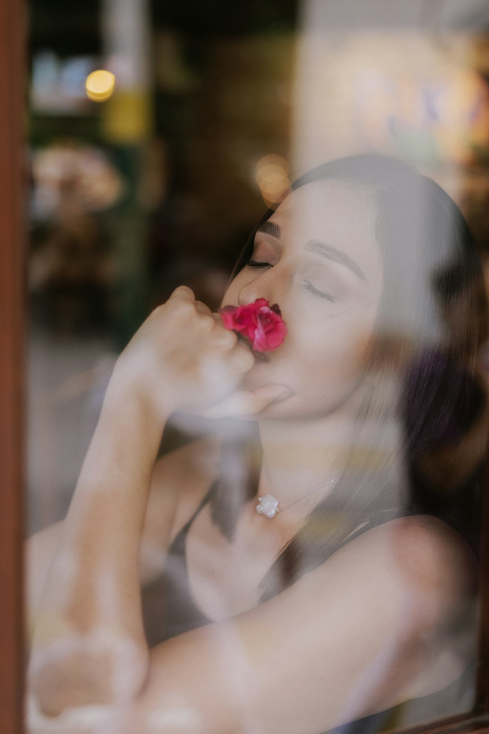 woman with pink flower on hand