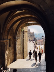 people standing beside concrete walls during daytime