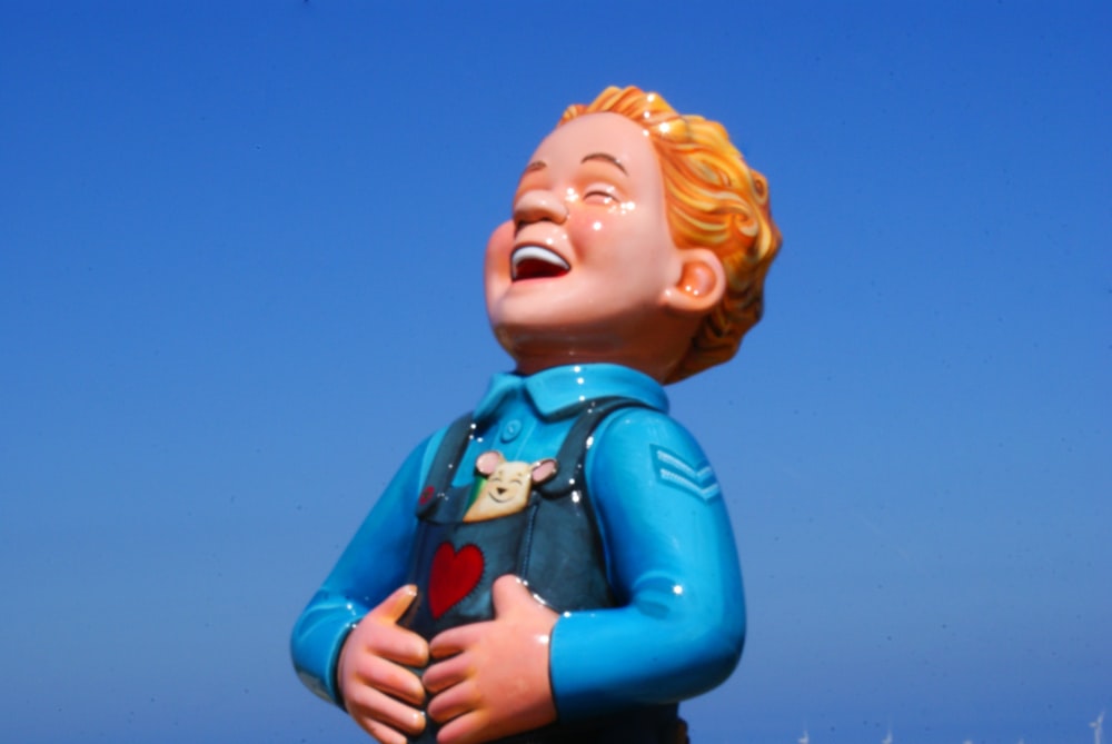 ceramic boy in blue laughing