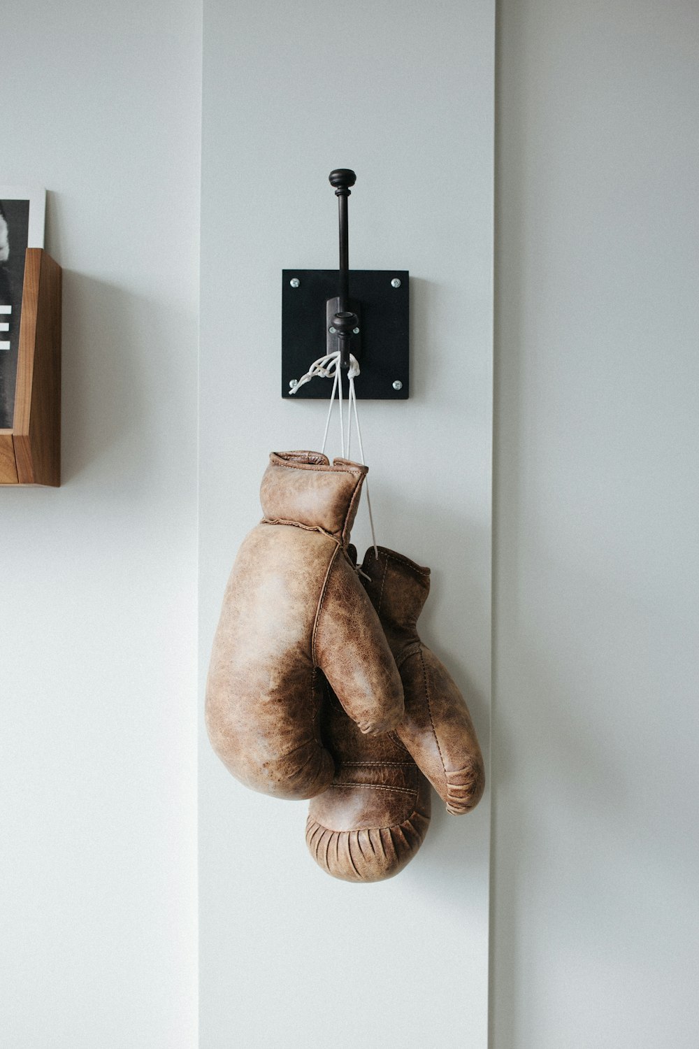 pair of brown leather boxing gloves hanged on wall