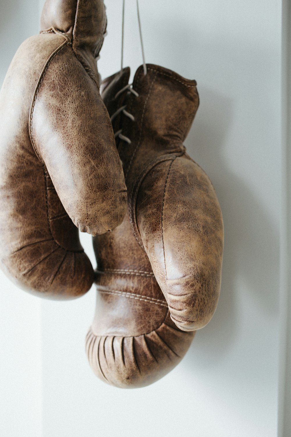 pair of brown leather boxing gloves