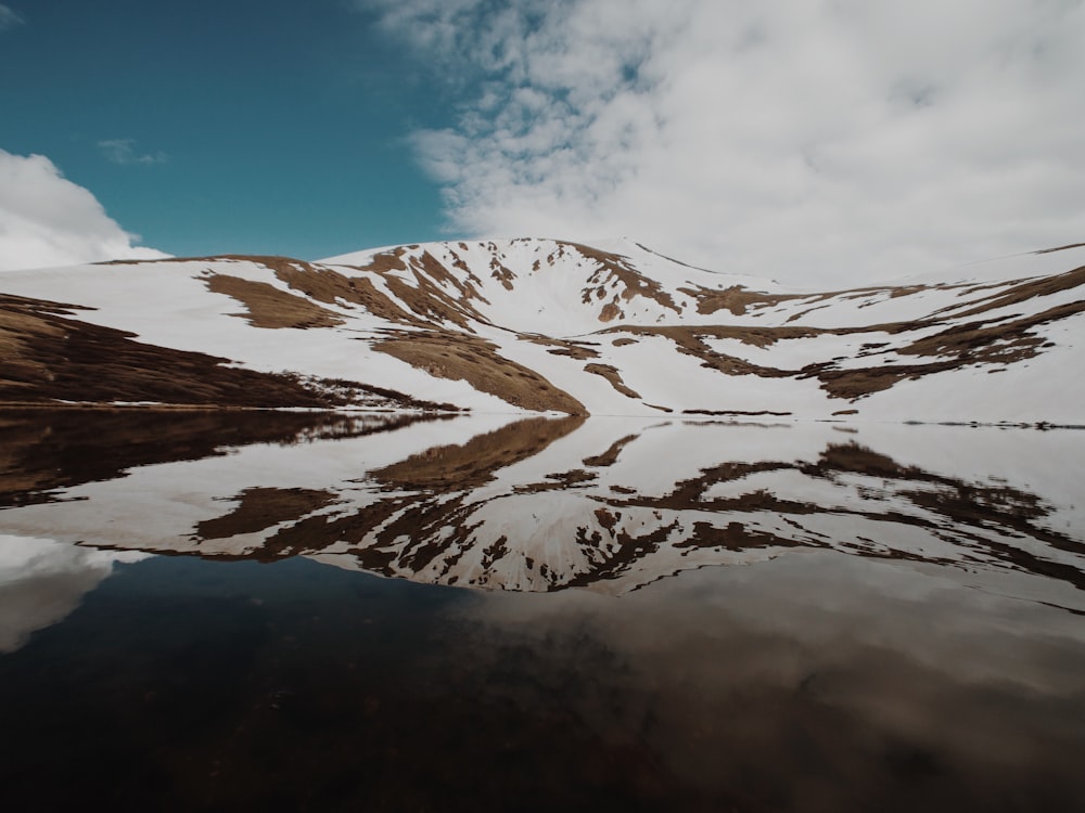 white and brown mountains under white and blue sky at daytime