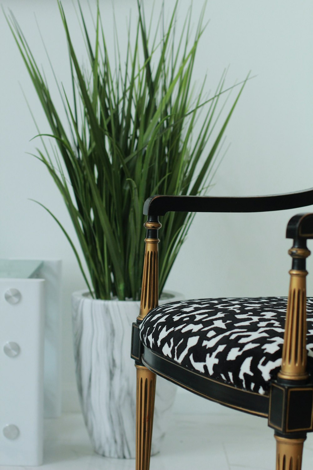 white and black leopard print padded armchair