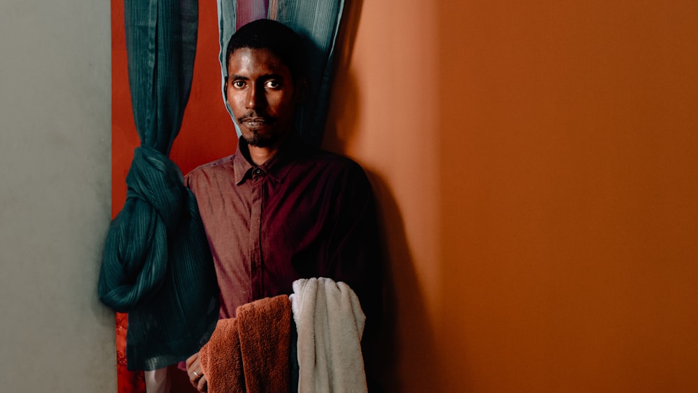 man standing beside the curtain