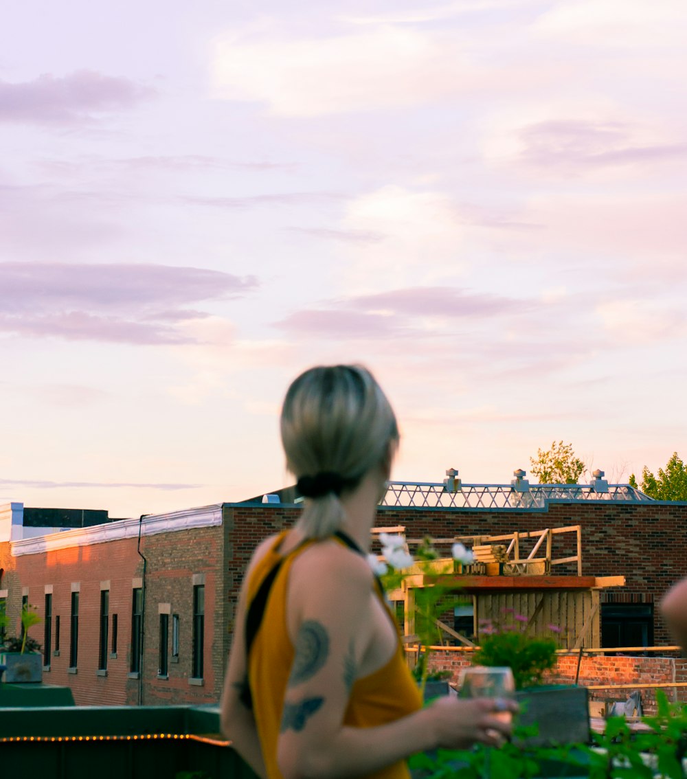 woman wearing orange tank top