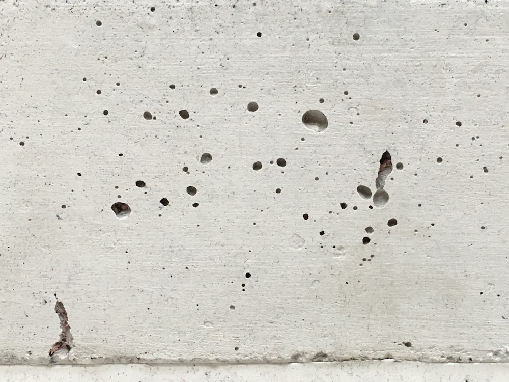 a cement wall with holes in it