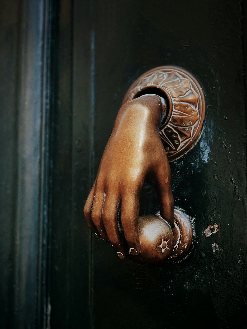 gold hand door knob