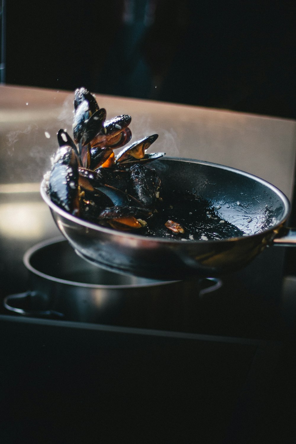 clams tossing on pan