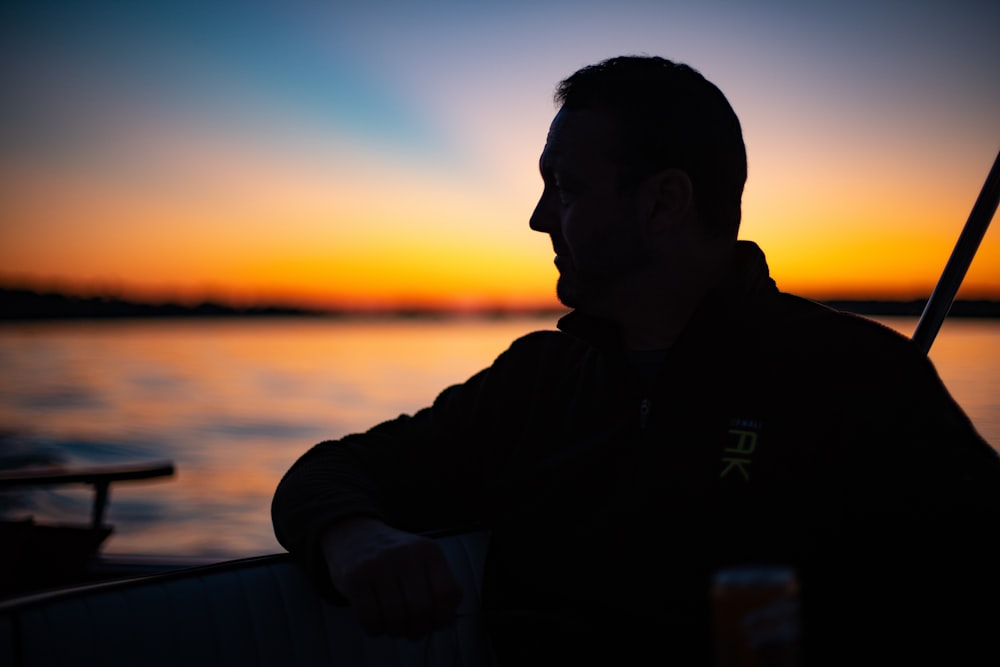 silhouette photography of man near ocean