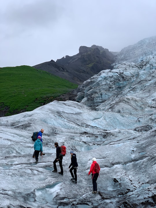 five people hiking going on mountain in Eastern Region Iceland