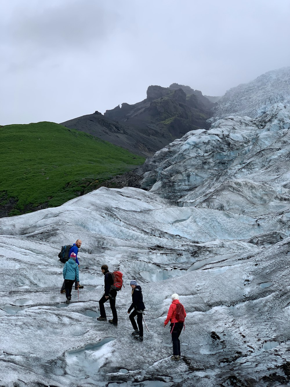 five people hiking going on mountain