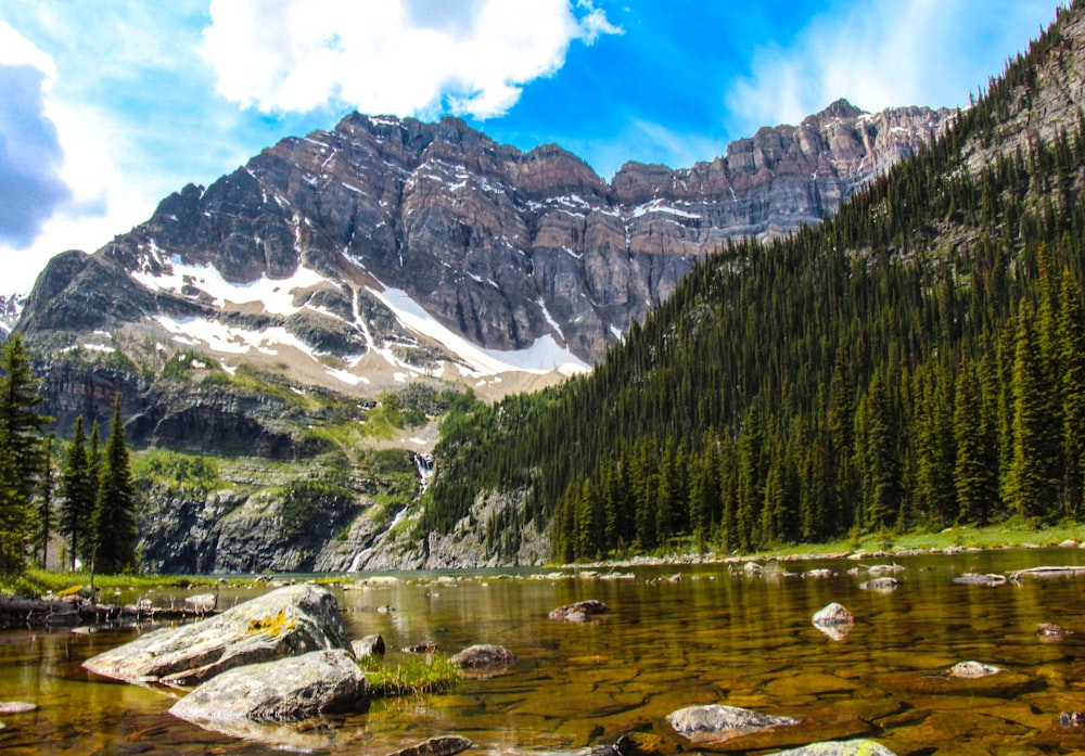 black and brown mountains under blue and white sky at daytime