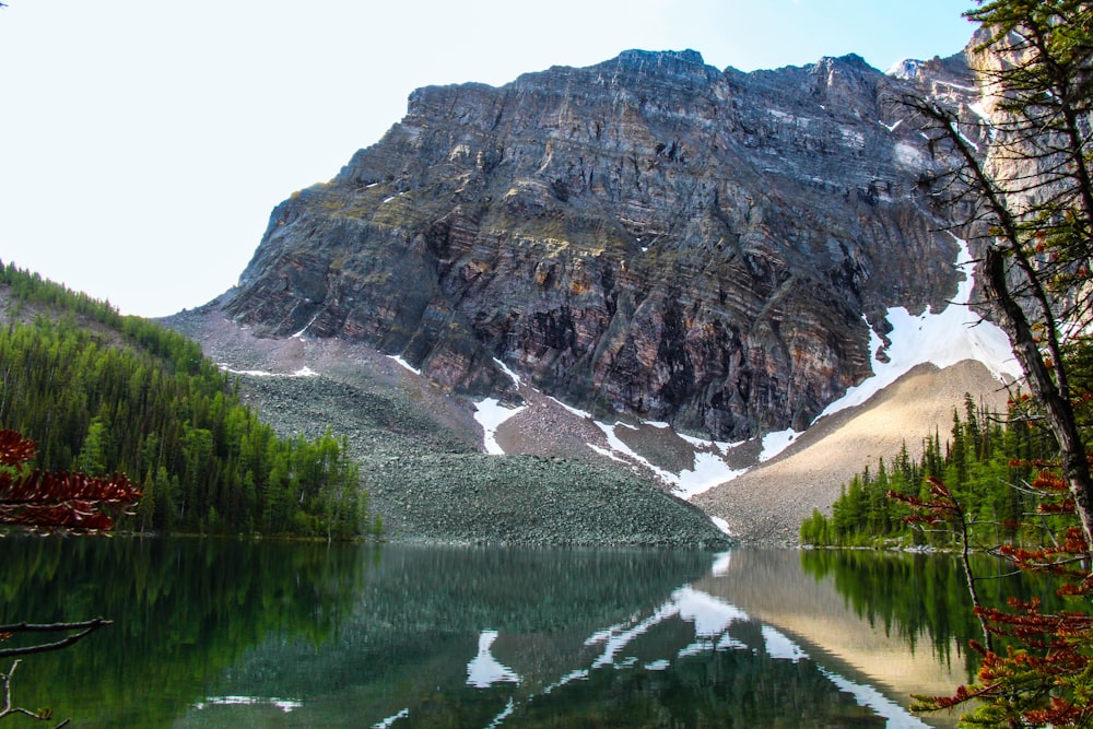 gray rock mountain over the lake an trees