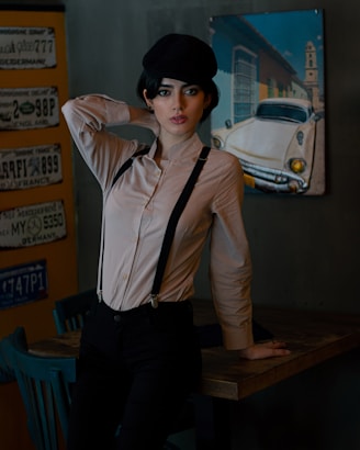 A vibrant airbrushed sweatshirt, hat, and license plate displayed on a rustic wooden table.