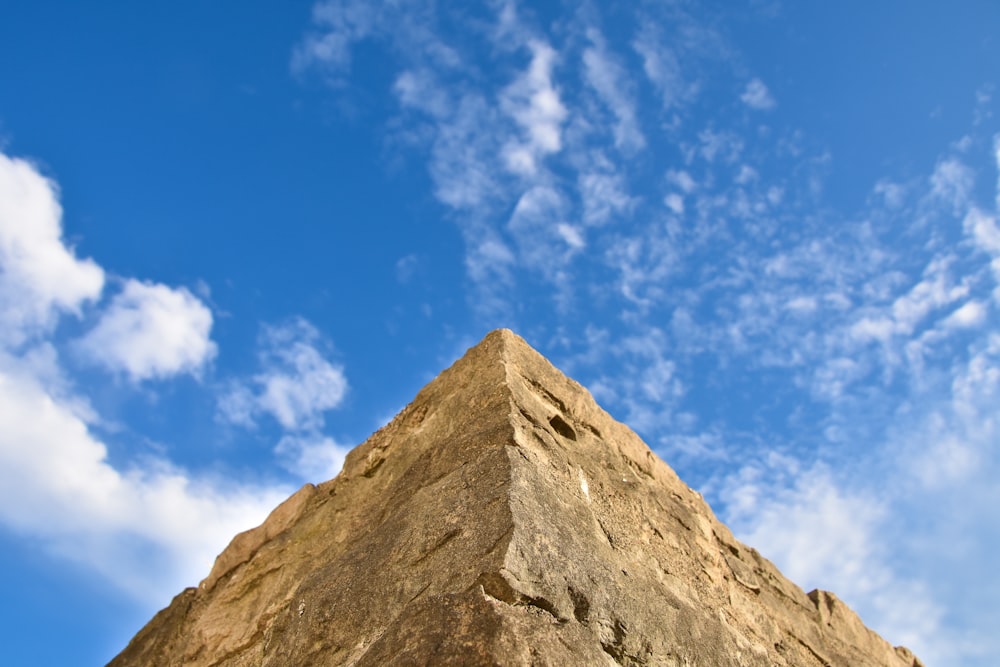 low-angle photography of brown wall under blue sky