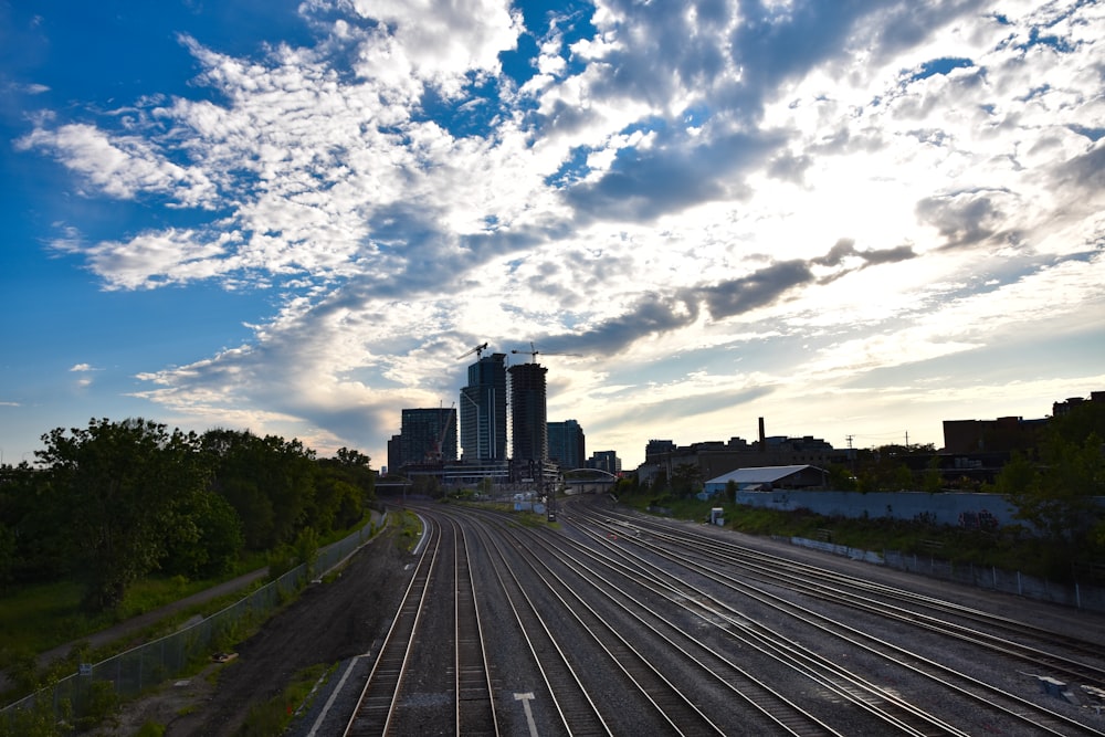 black and gray railways under white and blue sky