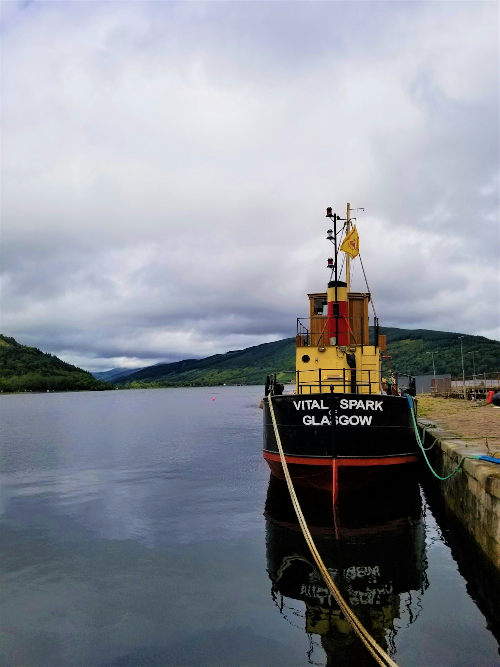 black and red boat on body of water at daytime