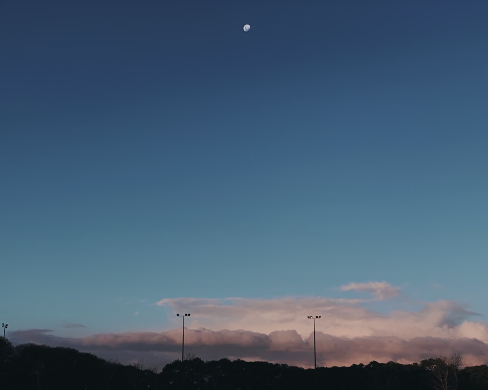 half moon at the sky over the grey clouds