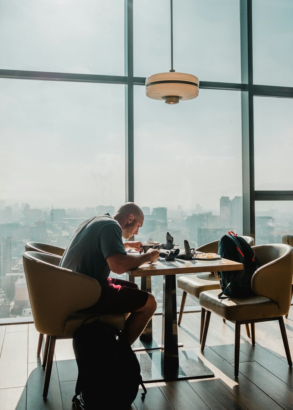 man in gray eating in a restaurant