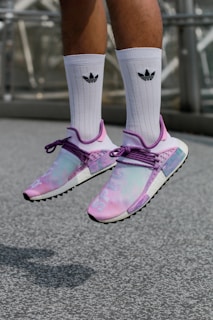 A close-up of a pair of dunk movement pilates socks in motion, with a playful dog running alongside.