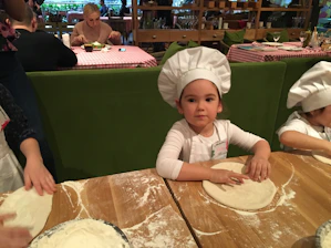 Happy kids receiving cooking club rewards and family vouchers.