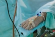 a person in a hospital bed with an iv