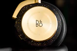 Stack of finished headphone units featuring sleek titanium shells and gold accents.