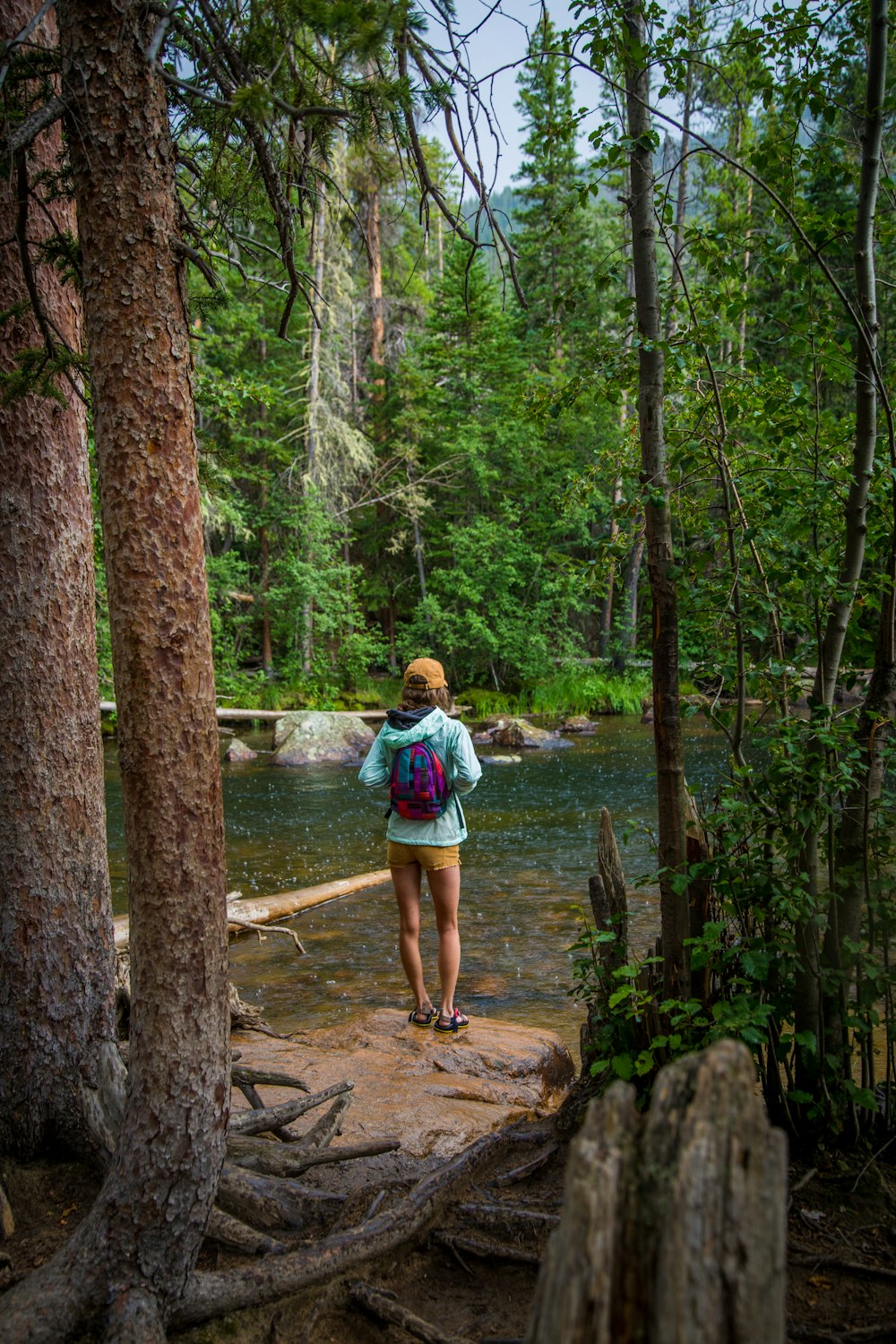 woman standing in front of river