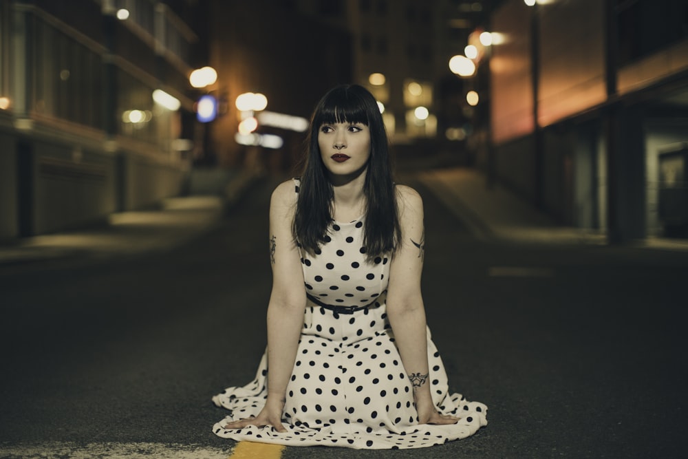 woman wearing white and black polka-dot dress