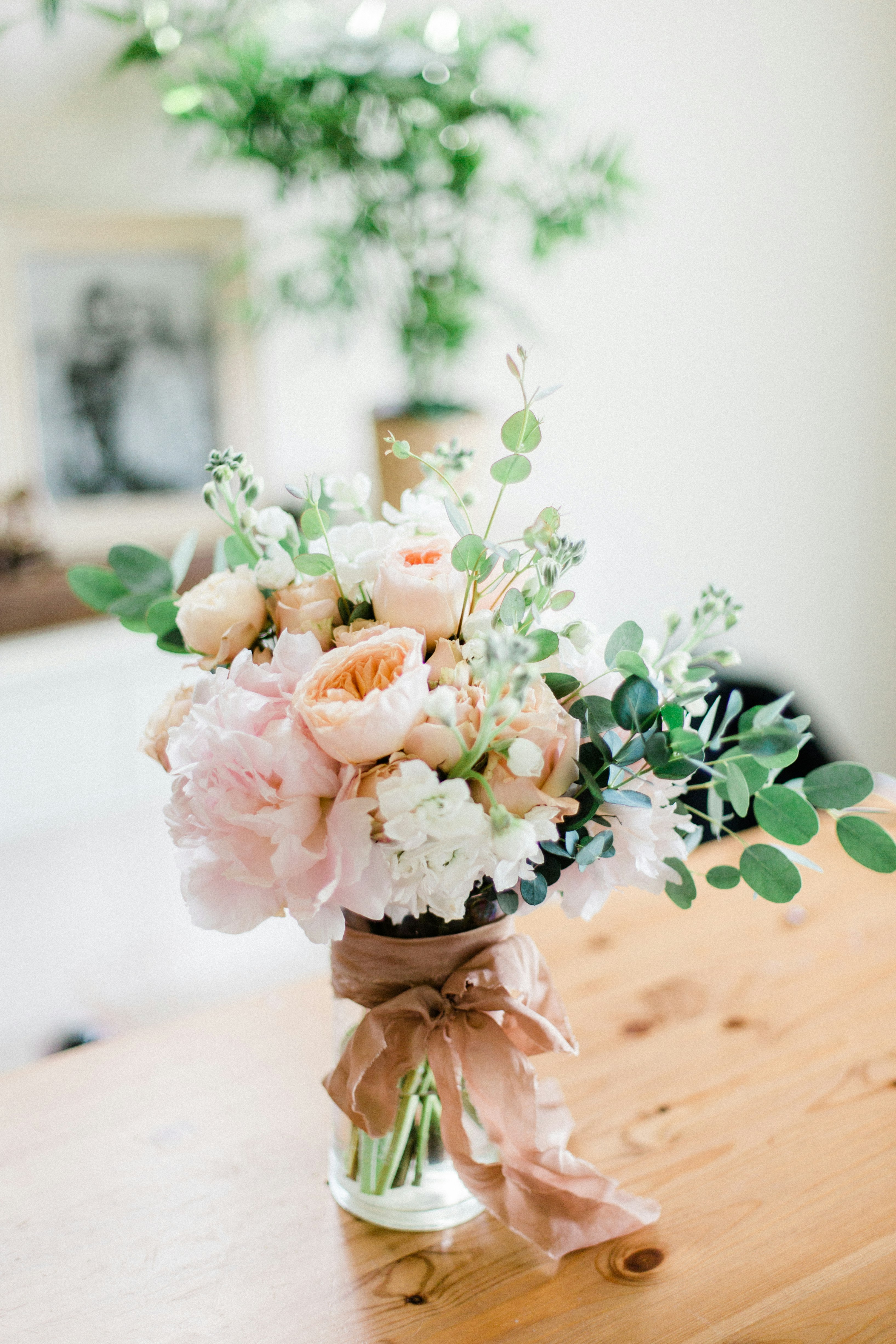 Elegantly wrapped wedding gifts with white ribbon and flowers