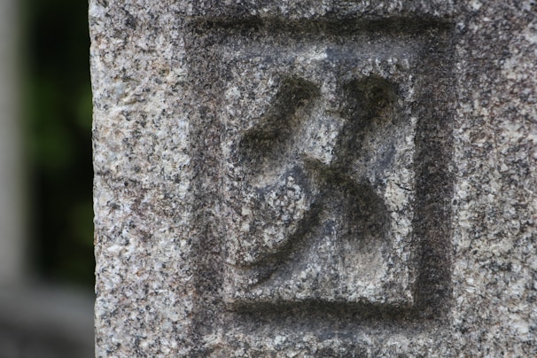 Close-up of a stone tile engraved with a custom logo and fine details.