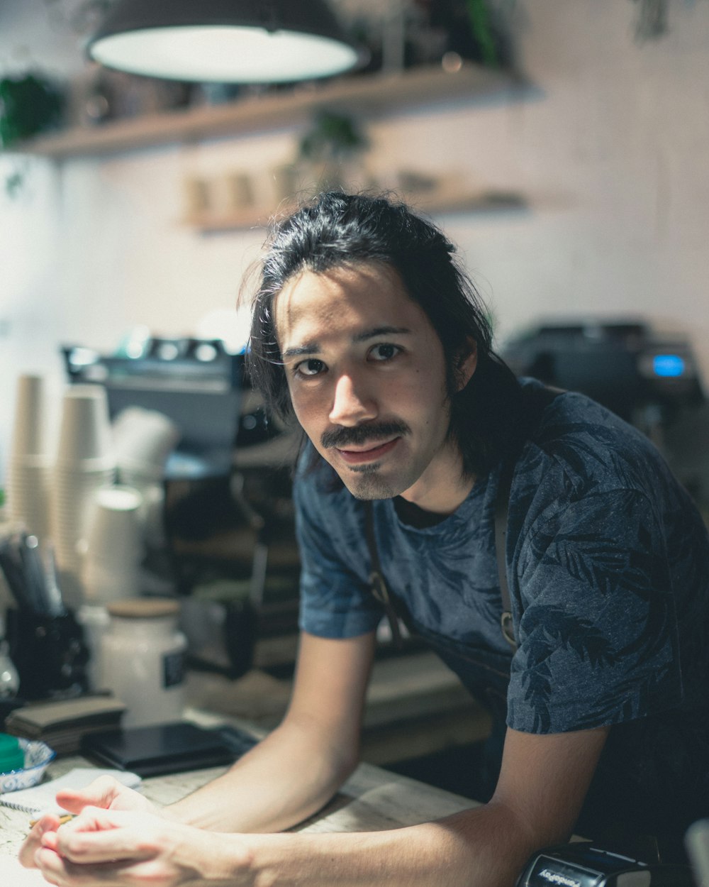 man leaning on table