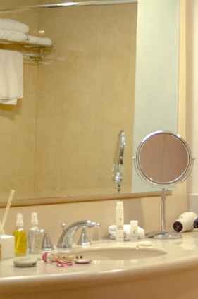 Bathroom sink area gleaming with cleaning products arranged nearby