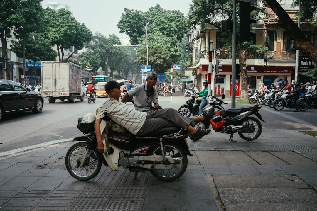 man lying on motorcycle during daytime