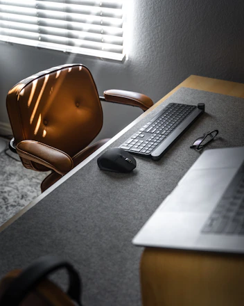 A sleek modern office desk with legal documents and a golden pen under soft natural light.