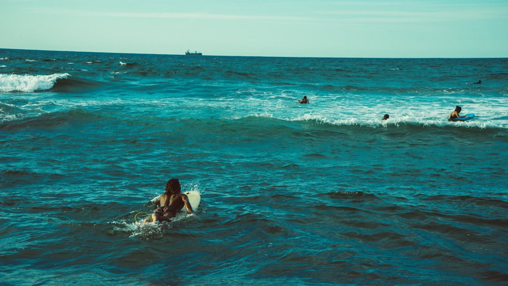woman riding on surfboard during daytime