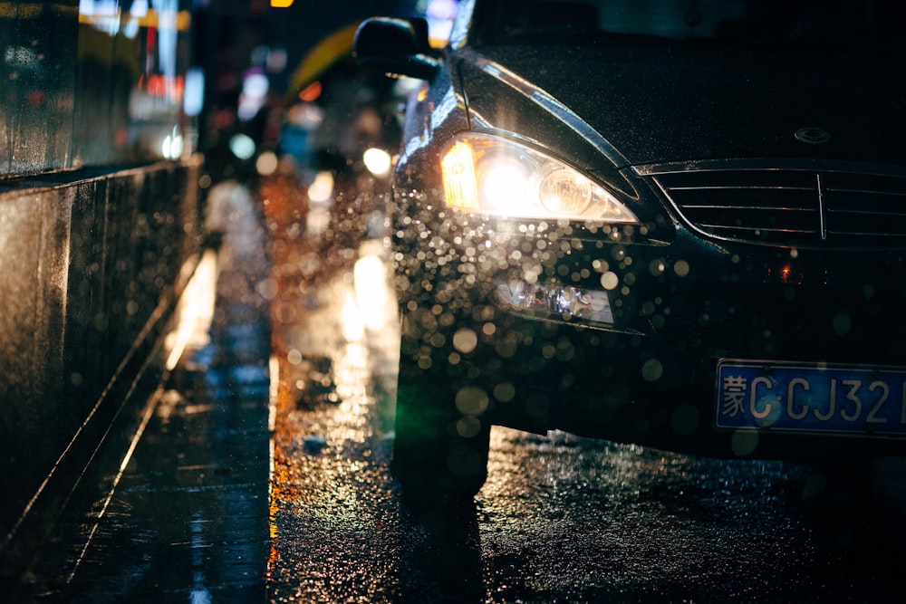 a car parked on the side of the road in the rain