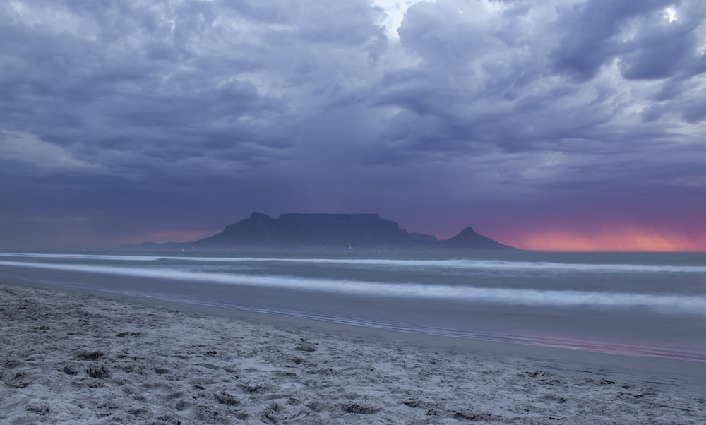 mountain and sea waves on shore