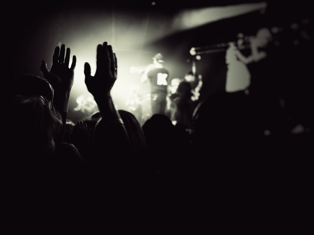 a crowd of people standing in front of a stage