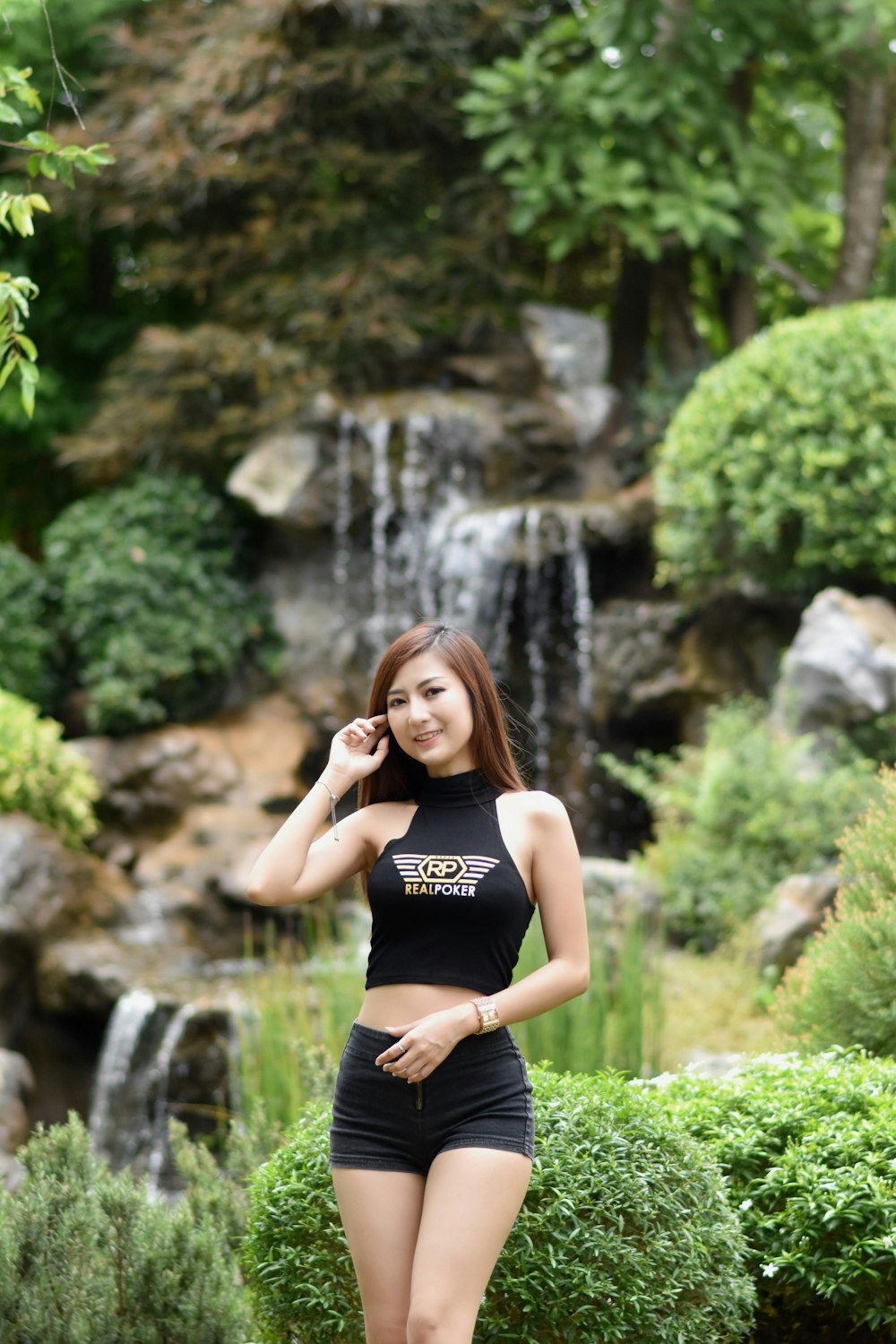 woman wearing Real Poker-printed halter top across waterfalls