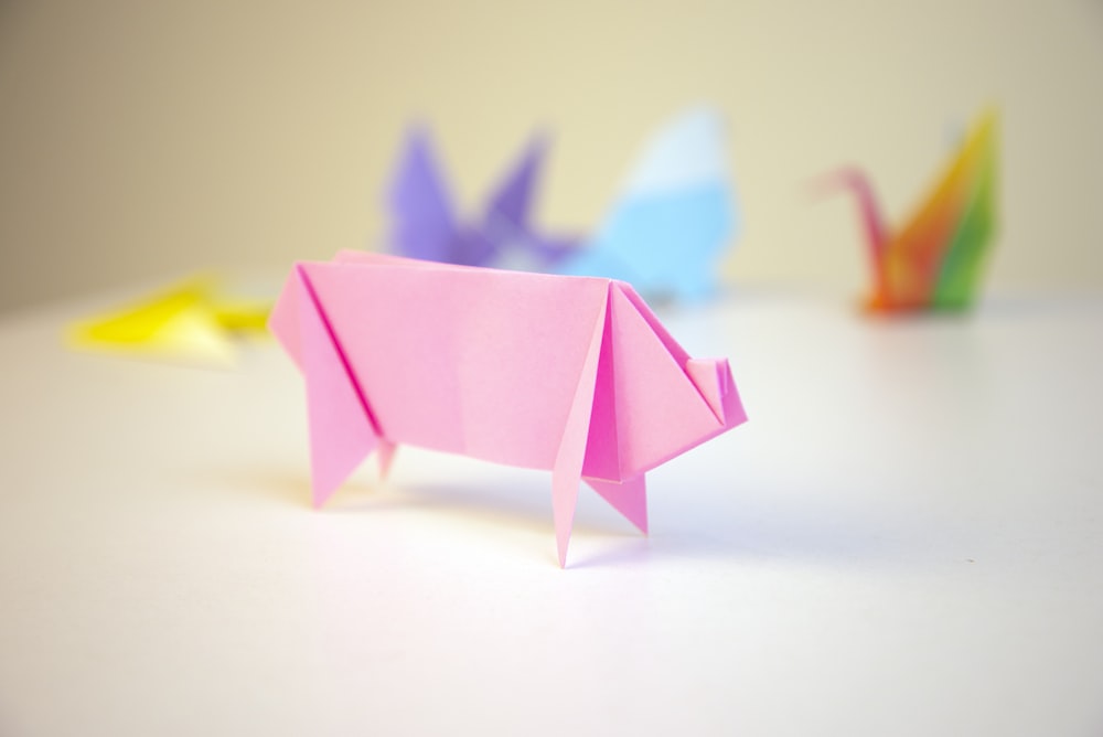 pink origami in front of other color origamis