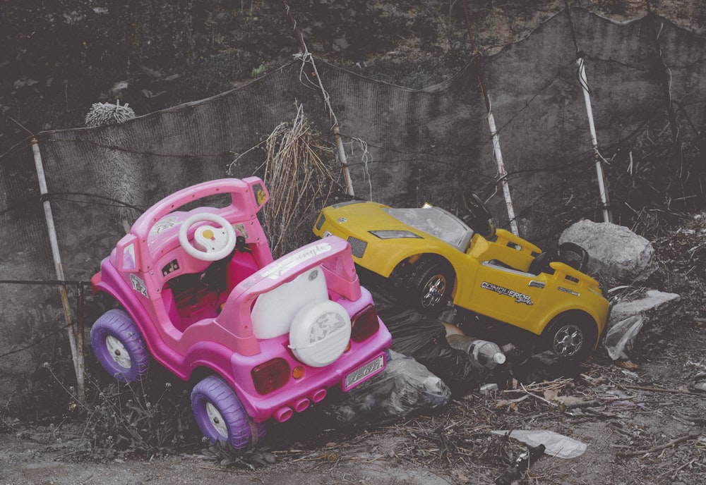 children's two pink and yellow ride-on vehicles