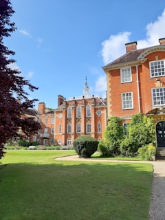 orange painted castle with green grass field scnery
