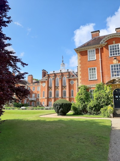 orange painted castle with green grass field scnery
