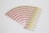 A collection of labels arranged in a fanned-out pattern, each featuring illustrations of a red factory with a green chimney and a yellow area with text and barcodes. The labels are neatly organized on a white background.