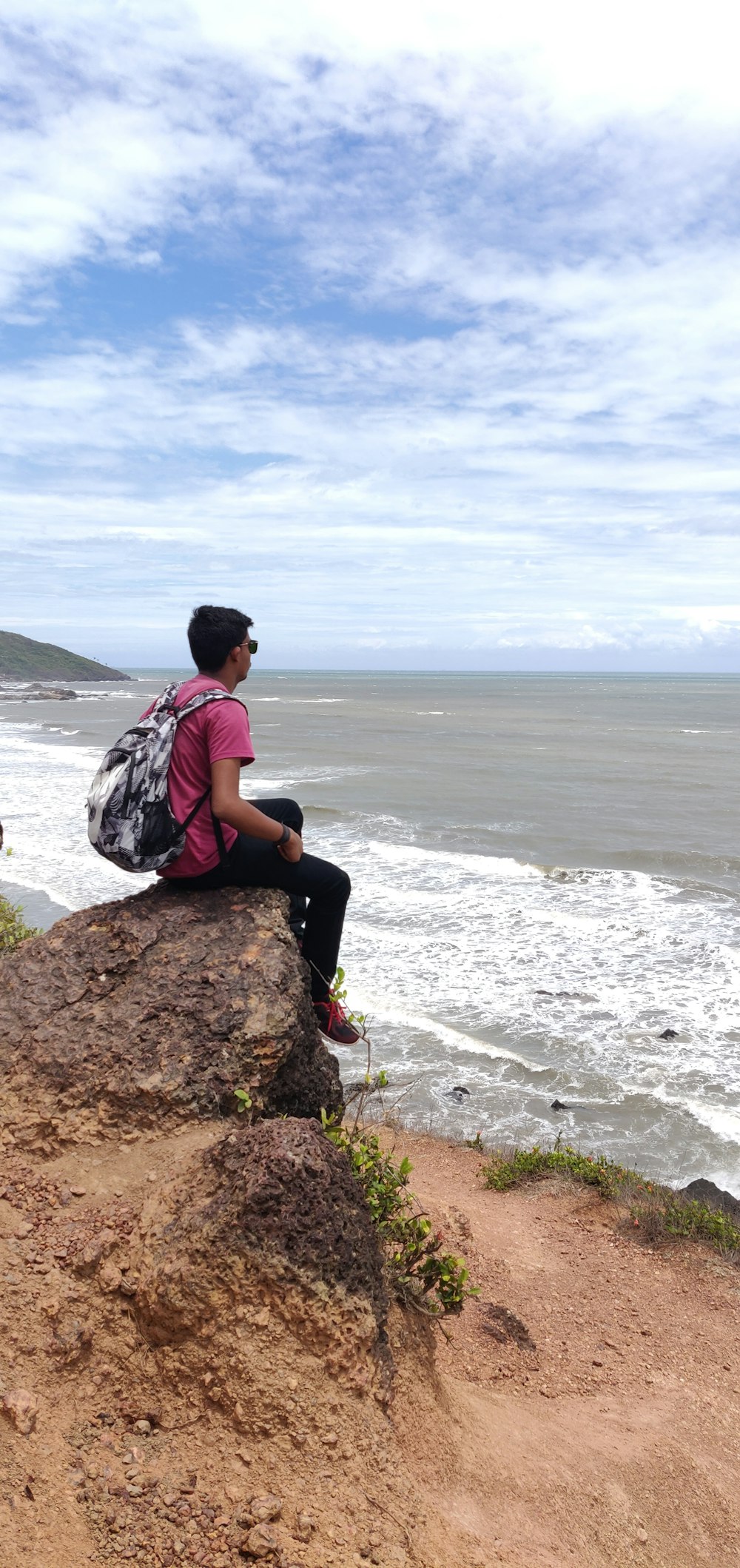 man sitting on rock