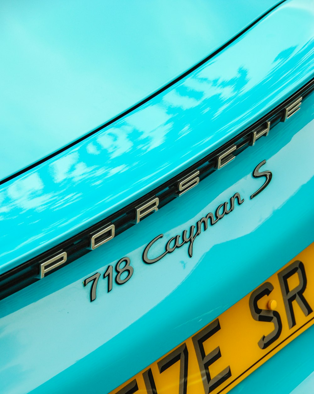 teal Porsche Cayman 718 S