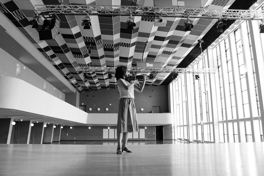 woman playing violin inside building