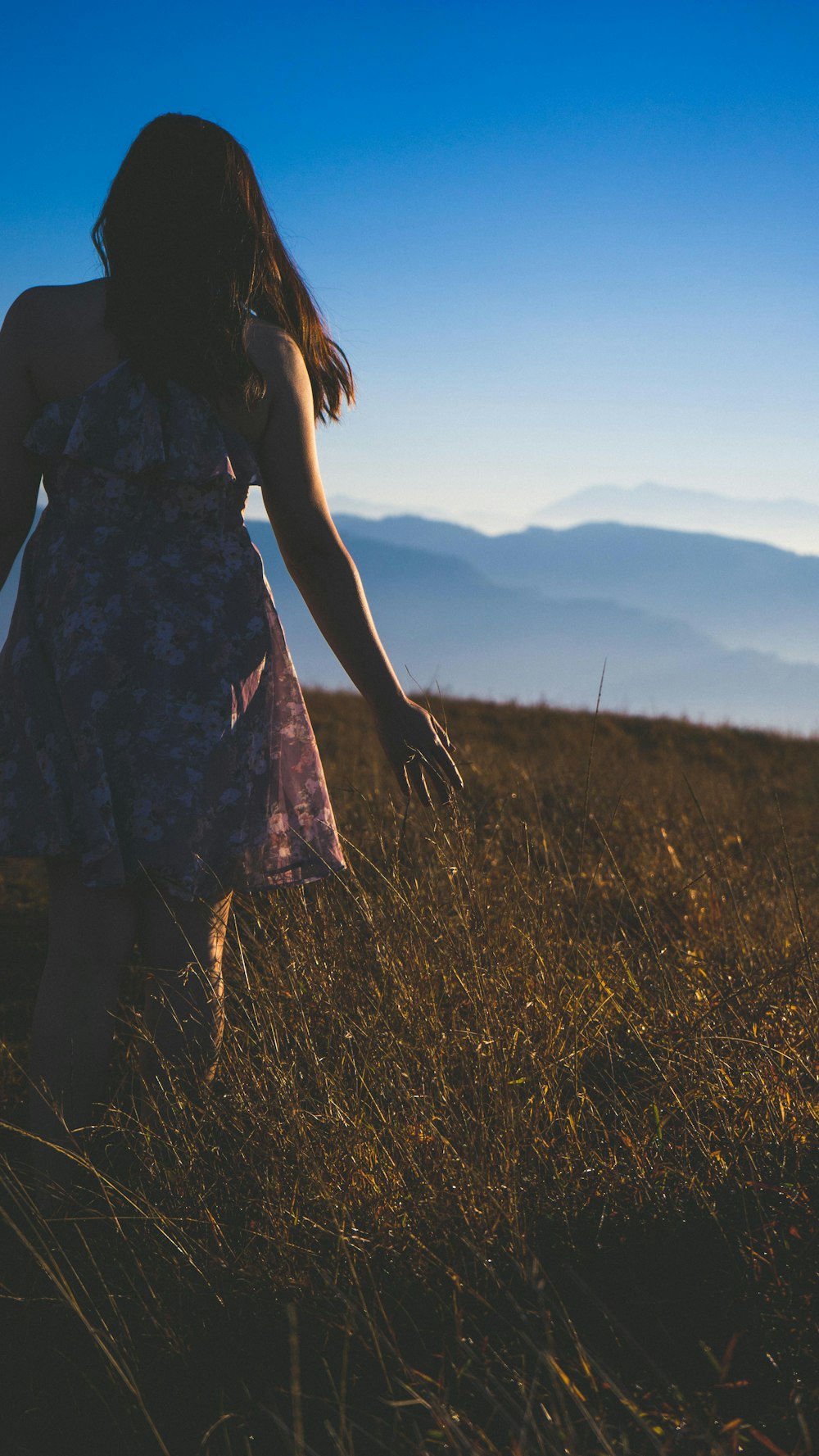 woman wearing dress standing on grass