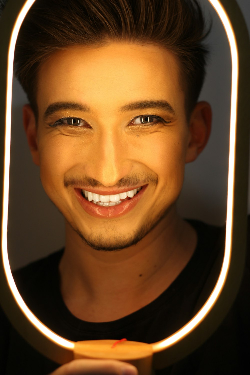 man smiling wearing black shirt